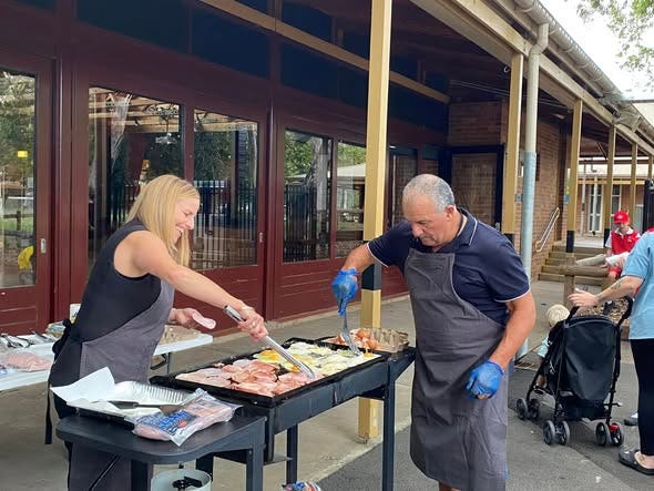 Principal and general assistant cooking a BBQ